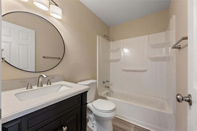 full bathroom with wood finished floors, shower / bathing tub combination, vanity, and toilet