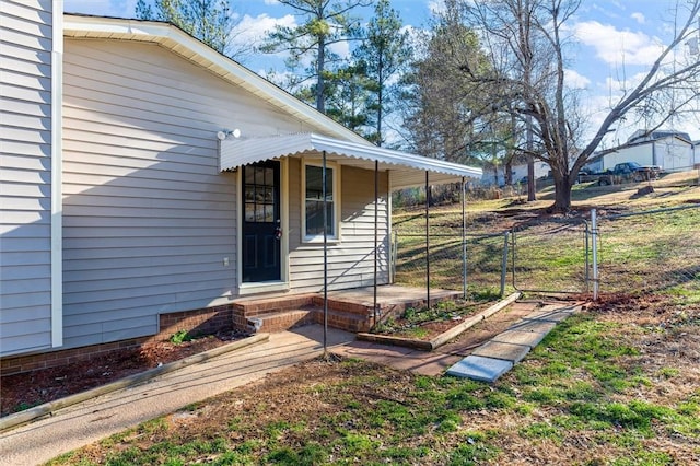 doorway to property with crawl space, a gate, and fence