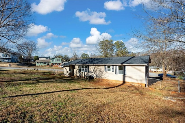 view of home's exterior with a gate, fence, and a yard