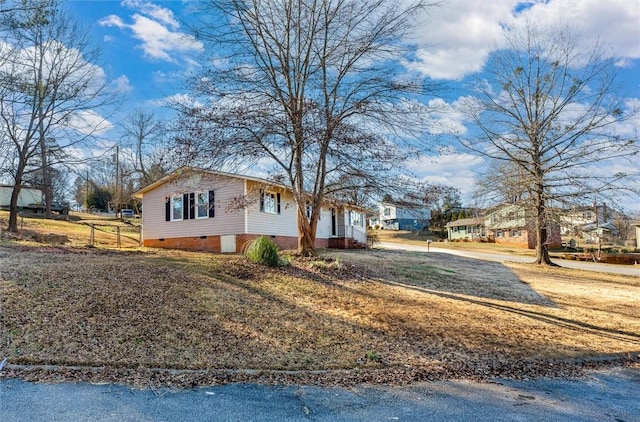 view of property exterior with crawl space and fence