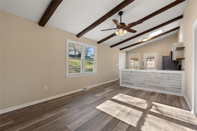 unfurnished living room featuring baseboards, visible vents, a ceiling fan, lofted ceiling with beams, and dark wood-type flooring