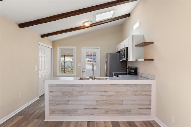 kitchen with vaulted ceiling with beams, open shelves, stainless steel appliances, white cabinetry, and a sink