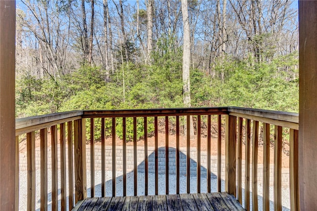 wooden deck with a wooded view