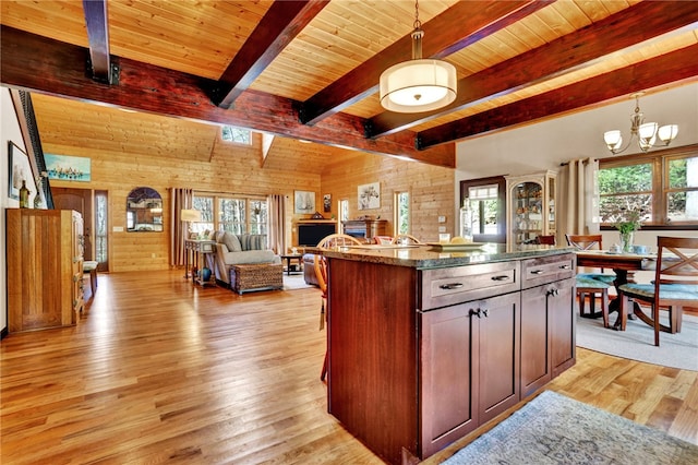 kitchen with decorative light fixtures, wood ceiling, and light wood-style floors