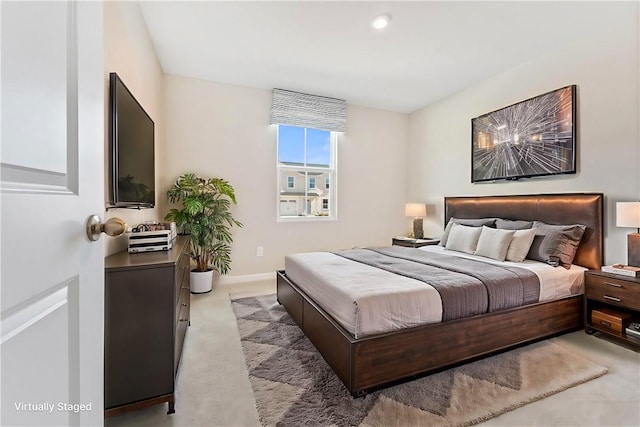 bedroom with baseboards and light colored carpet