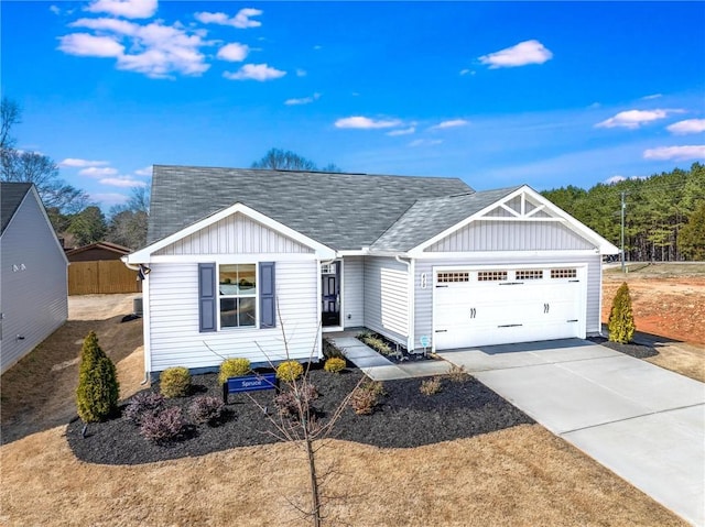 ranch-style house featuring driveway, board and batten siding, an attached garage, and a shingled roof