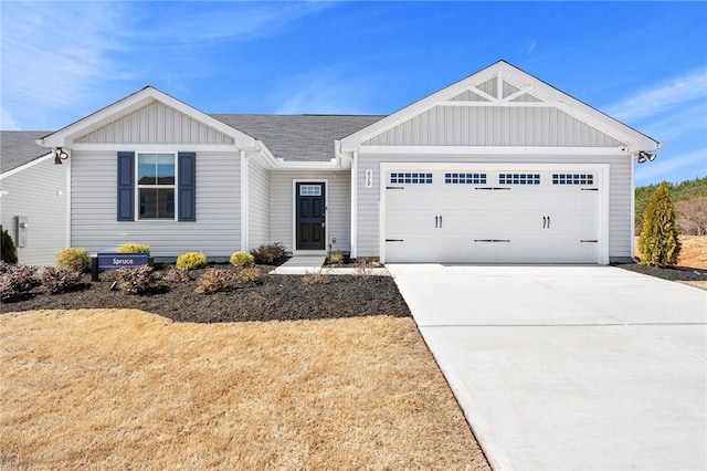 single story home with an attached garage, board and batten siding, a shingled roof, and concrete driveway