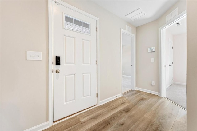 entrance foyer with baseboards, visible vents, and light wood-style floors