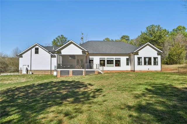 back of property featuring a yard, crawl space, and a sunroom