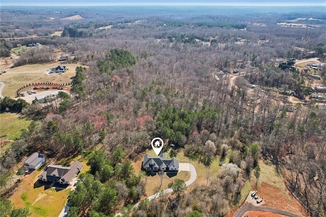 drone / aerial view featuring a forest view