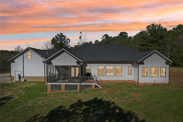 rear view of house featuring crawl space and a yard