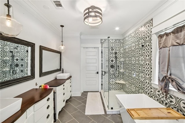 bathroom featuring a washtub, vanity, ornamental molding, tile patterned floors, and a stall shower