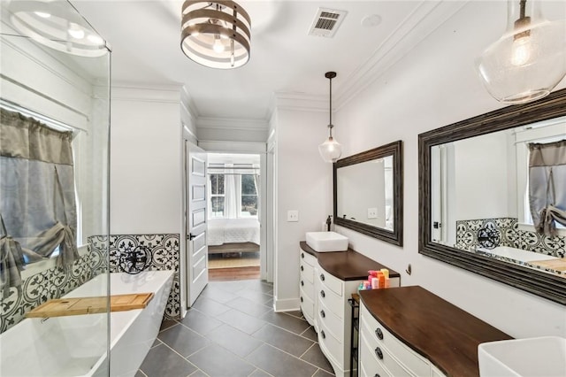 full bathroom with a freestanding tub, ensuite bath, visible vents, and crown molding