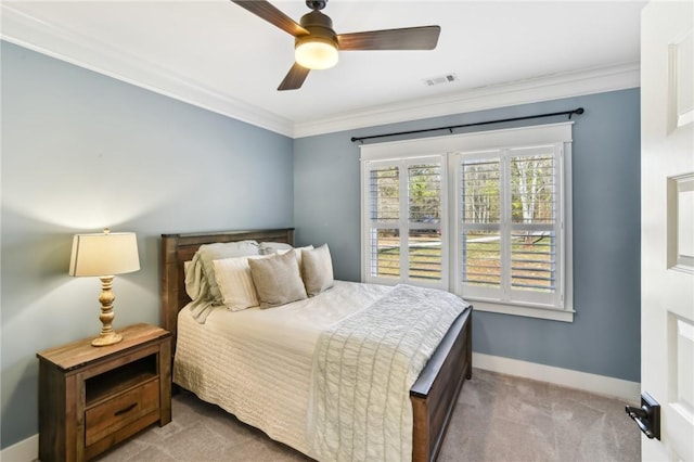 carpeted bedroom with ornamental molding, a ceiling fan, visible vents, and baseboards