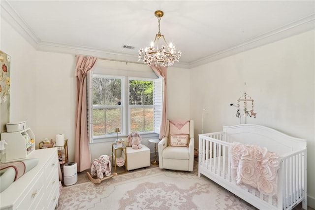 bedroom with a chandelier, a crib, visible vents, and crown molding