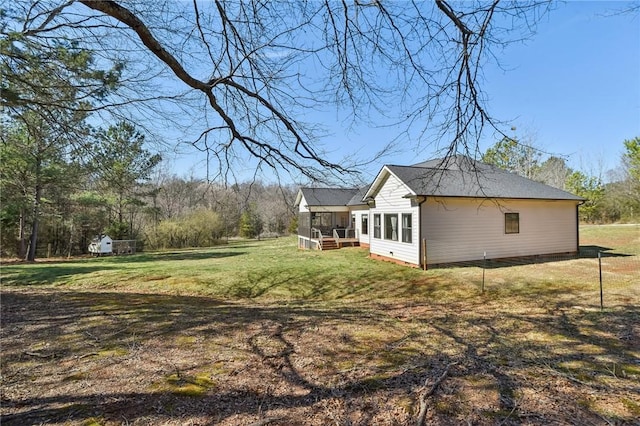 view of home's exterior featuring a sunroom, a yard, and crawl space