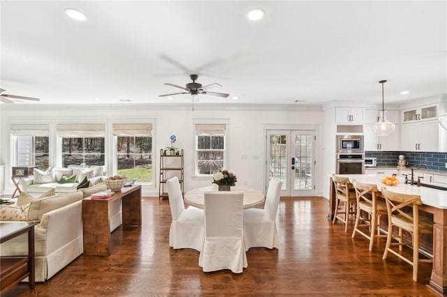 dining room featuring ceiling fan, ornamental molding, dark wood-style flooring, french doors, and recessed lighting