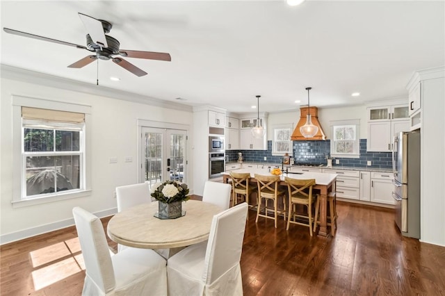 dining area featuring recessed lighting, dark wood-style flooring, baseboards, ornamental molding, and french doors