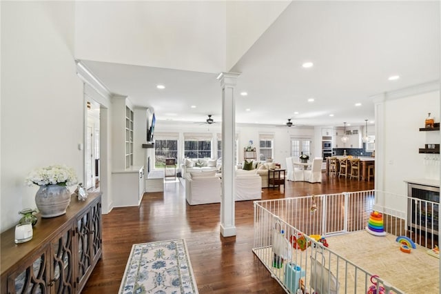 entryway with dark wood-style floors, a wealth of natural light, decorative columns, and recessed lighting