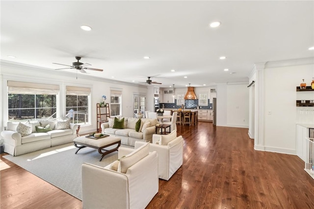 living area featuring baseboards, dark wood-type flooring, recessed lighting, and crown molding