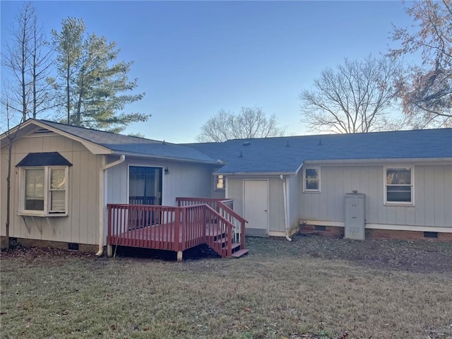 back of property featuring a shingled roof, crawl space, a lawn, and a wooden deck