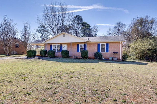 single story home with brick siding and a front lawn