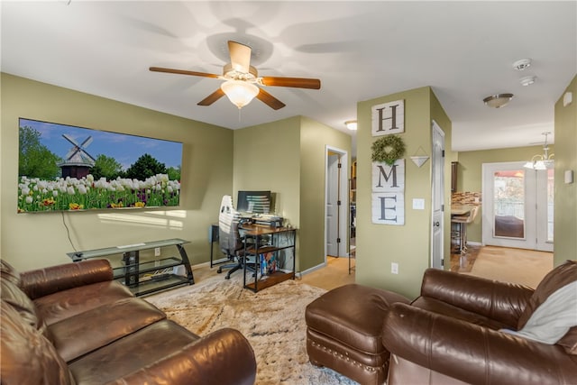 carpeted living room with a ceiling fan and baseboards