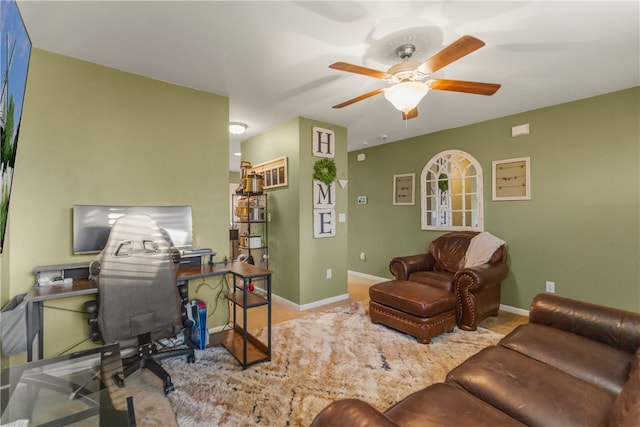 office featuring baseboards and a ceiling fan