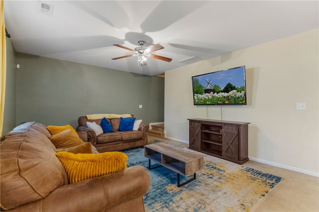 carpeted living area with baseboards, visible vents, and a ceiling fan