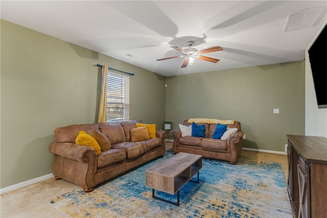 living area with carpet, visible vents, ceiling fan, and baseboards