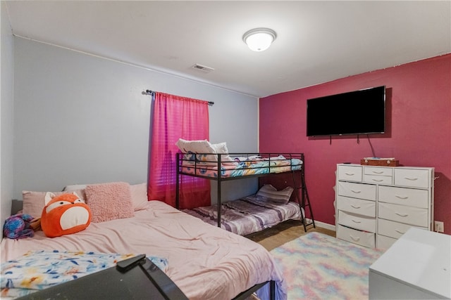 bedroom with visible vents and baseboards