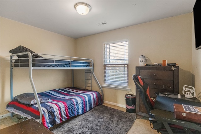 bedroom with carpet, visible vents, and baseboards