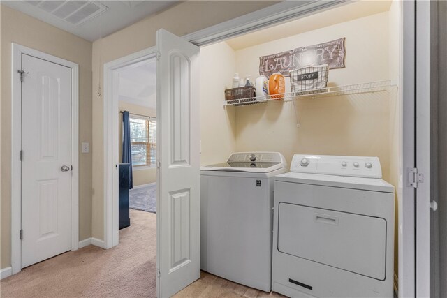 washroom featuring light carpet, laundry area, separate washer and dryer, visible vents, and baseboards