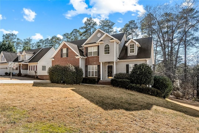 view of front of house featuring brick siding and a front lawn