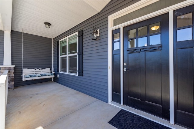 doorway to property with covered porch