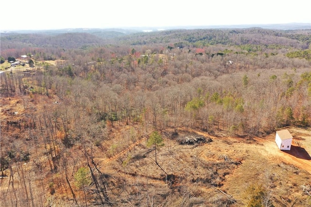 drone / aerial view featuring a forest view