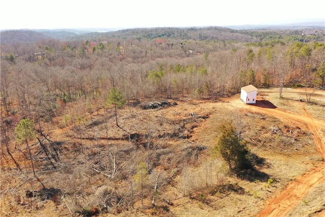 drone / aerial view featuring a wooded view