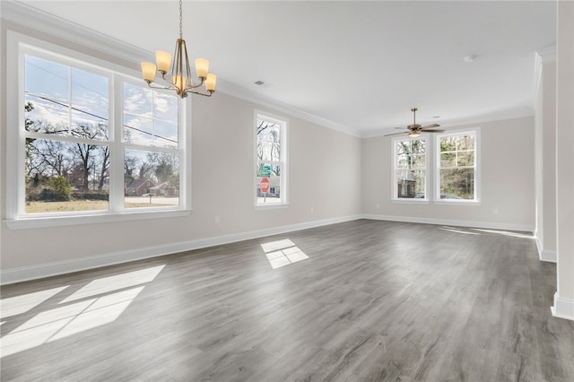 unfurnished dining area featuring baseboards, visible vents, ornamental molding, wood finished floors, and ceiling fan with notable chandelier