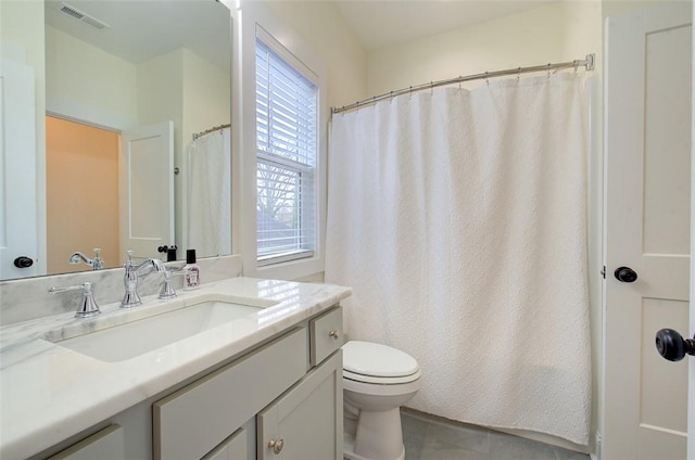 bathroom with visible vents, vanity, and toilet