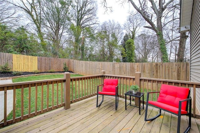 wooden deck featuring a fenced backyard and a yard