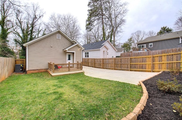 back of house featuring a fenced backyard, a yard, central AC, and a wooden deck