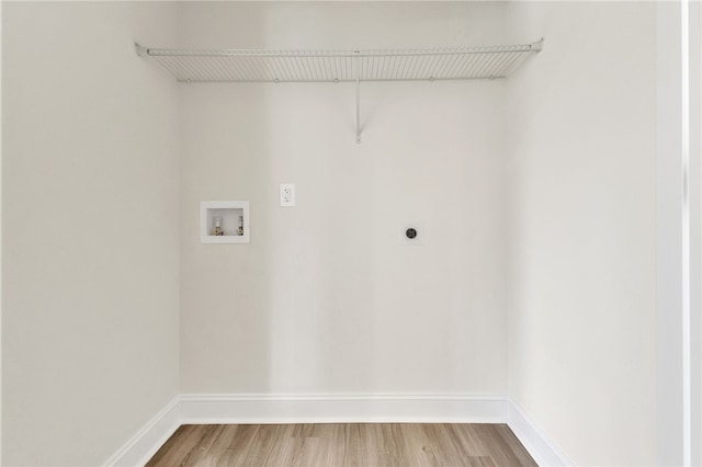 laundry room featuring hookup for a washing machine, hookup for an electric dryer, light wood-type flooring, laundry area, and baseboards