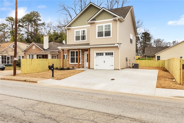 craftsman-style house featuring cooling unit and fence