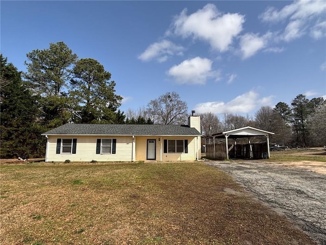 ranch-style house with a carport, a front yard, gravel driveway, and a chimney