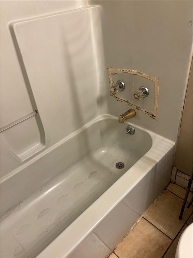 full bathroom featuring toilet and tile patterned floors