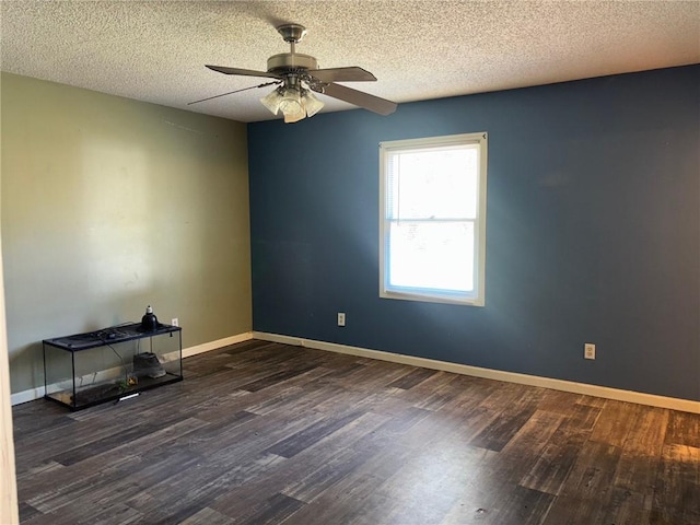 unfurnished room featuring a ceiling fan, baseboards, and wood finished floors