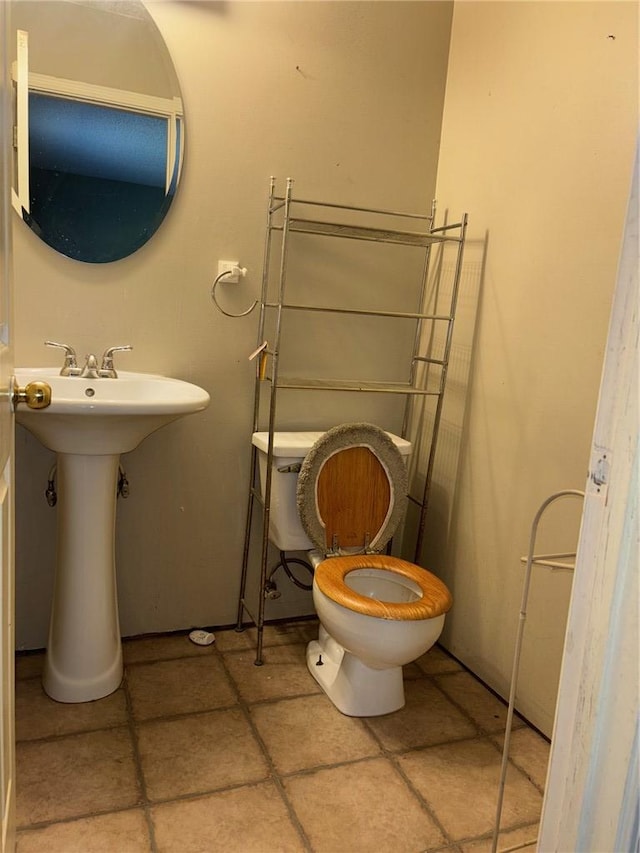 half bathroom with a sink and toilet