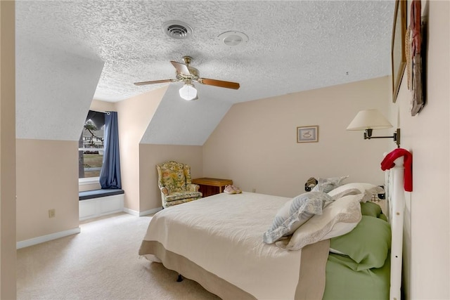 bedroom with carpet, visible vents, lofted ceiling, and a textured ceiling