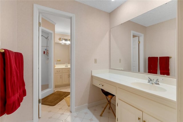 bathroom with a stall shower, tile patterned floors, vanity, and baseboards