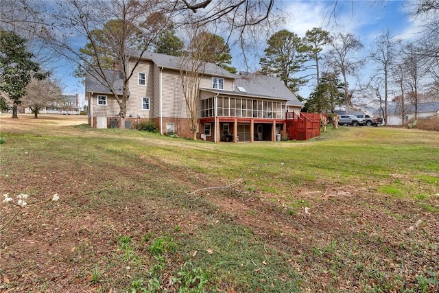 back of property featuring a yard and a sunroom